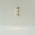 Soleil wall sconce in fluted glass with brushed brass accents