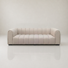 Bianca curved sofa in mushroom boucle with channel tufting